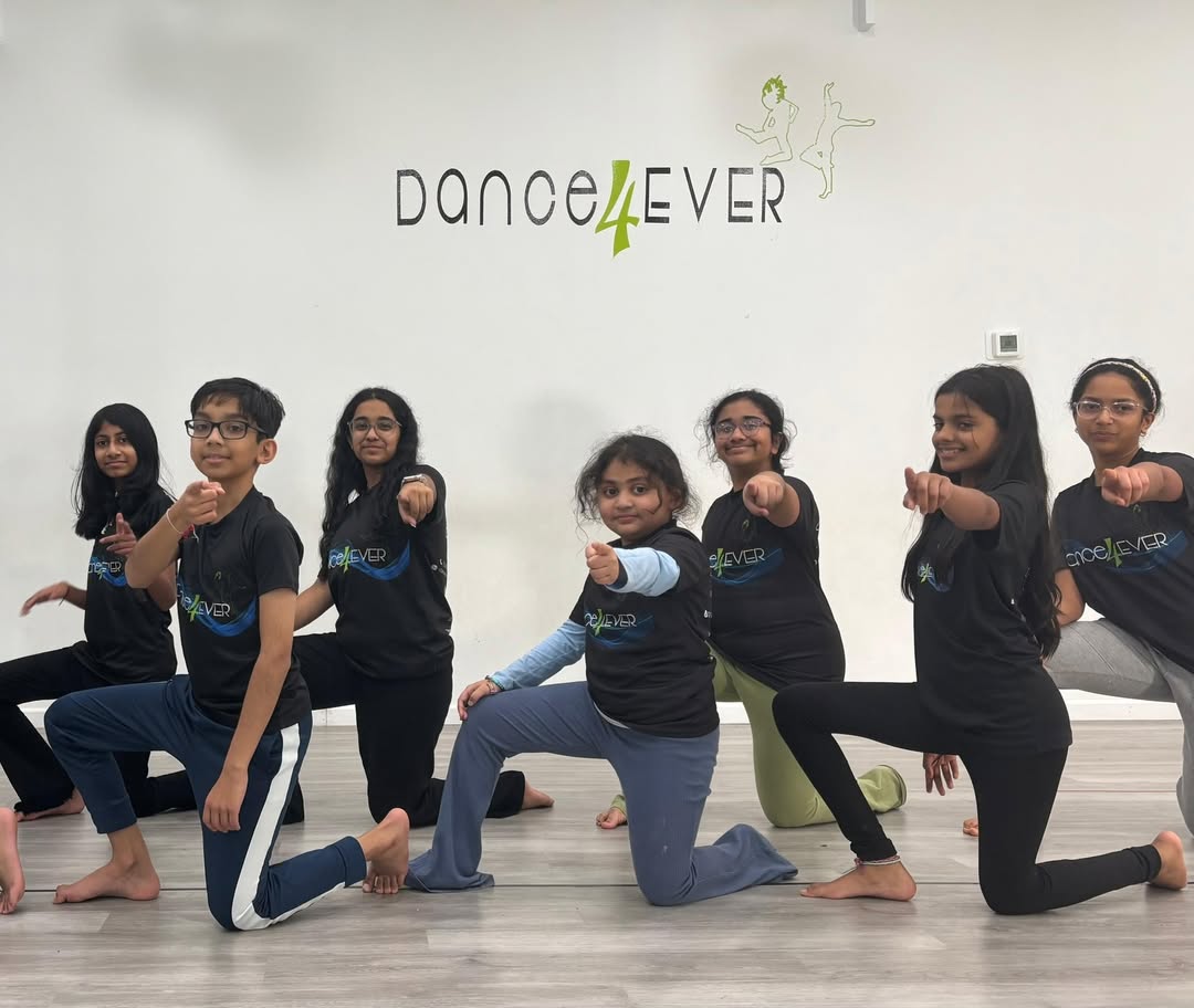 A kids batch posing in the studio in Dance4Ever t-shirts
