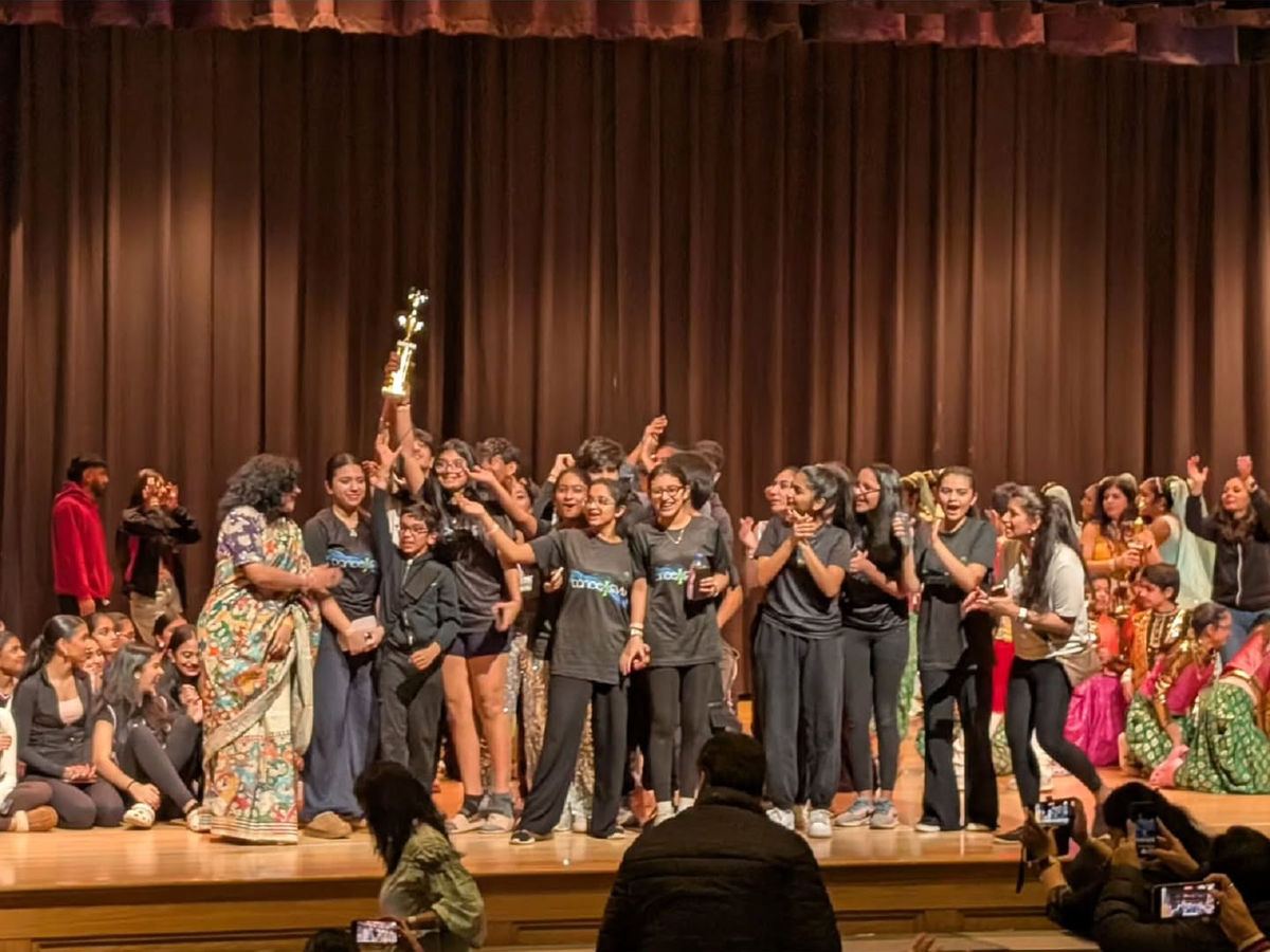 The Dance4Ever team celebrating a win on stage